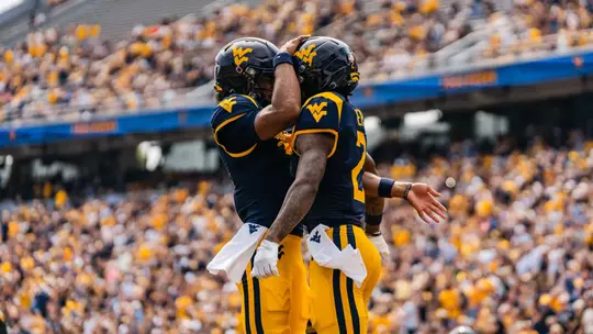 Two players celebrate after scoring a touchdown against UT Martin at Milan Puskar Stadium on Sept. 12, 2026.