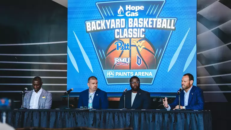 West Virginia University vice president and director of athletics Wren Baker answers a question during Wednesday's press conference at PPG Paints Arena in Pittsburgh announcing the 2026 Hope Gas Backyard Brawl Basketball Classic.