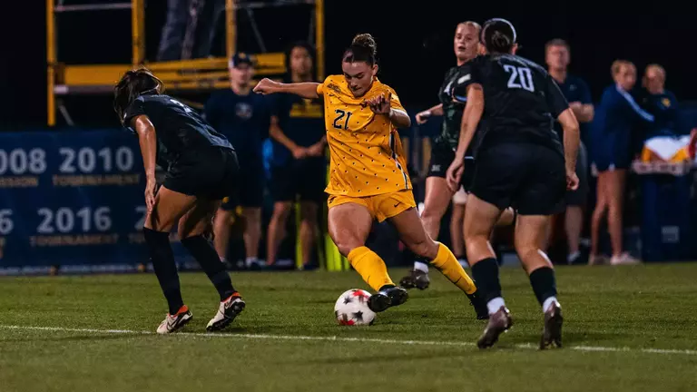 Alexis Re dribbles past a defender during a match at Dick Dlesk Soccer Stadium.