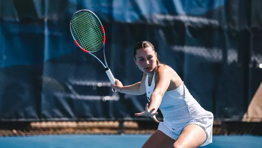 Lucia Tognoni returns a serve during a tennis match