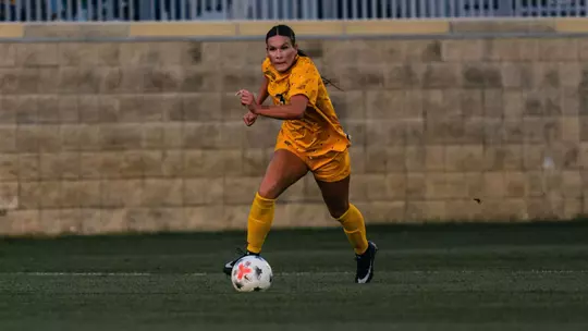 Jacey Rase dribbles down the field during a match at Dick Dlesk Soccer Stadium.