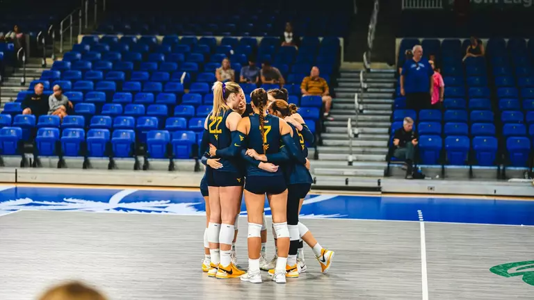 WVU huddles as they take on FAU in the Sunshine State Classic