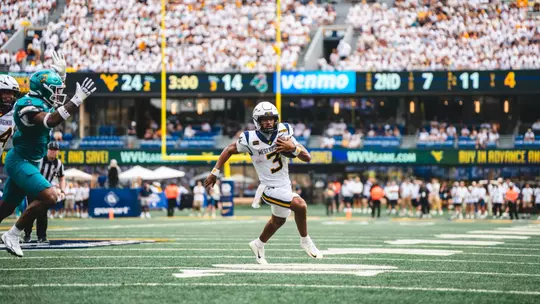 Quarterback Michael Hawkins Jr. (3) scores his first career rushing touchdown as a Mountaineer in the fourth quarter against Coastal Carolina on Sept. 5, 2026.
