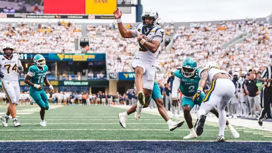 Quarterback Michael Hawkins scores an 11-yard touchdown in the fourth quarter of West Virginia's 31-24 victory over Coastal Carolina at Milan Puskar Stadium.