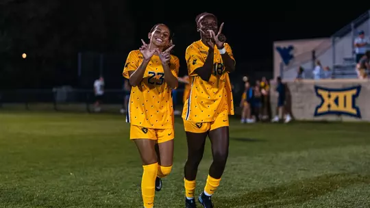 Members of the WVU women's soccer team celebrate a win on Sept. 6.