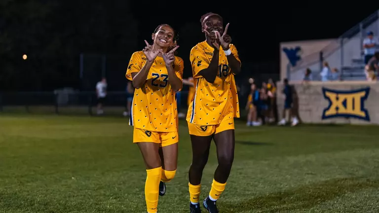 Members of the WVU women's soccer team celebrate a win on Sept. 6.