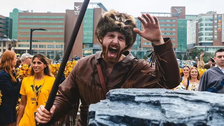 The Mountaineer mascot touches a slab of coal during the pregame team entrance into the stadium prior to West Virginia's 31-24 season-opening victory over Coastal Carolina on Saturday, Sept. 5, 2026,