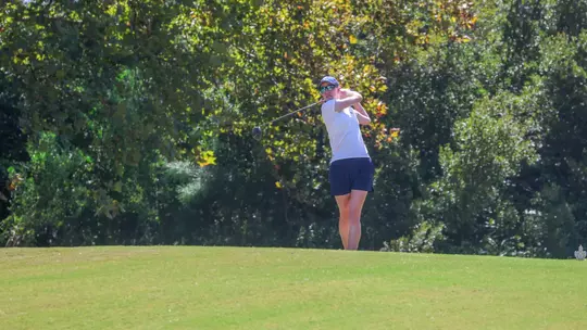 Addie Doroh watches her tee shot while holding her follow-through