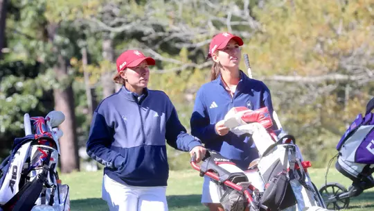 Calle Barlow, Katie Magner stare down a tee shot from a member of the threesome