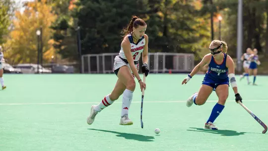 Spider field hockey's Jess McMeeking drives past her American defender