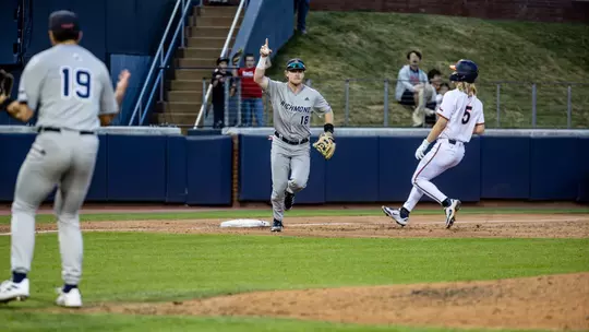 Brady O'Brien celebrates the victory over Virginia after stepping on third