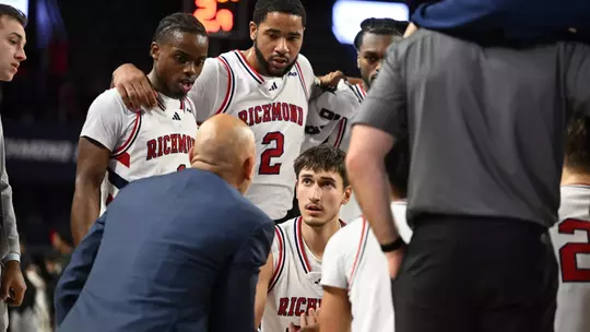 Spiders listen to Coach David Boyden during a timeout