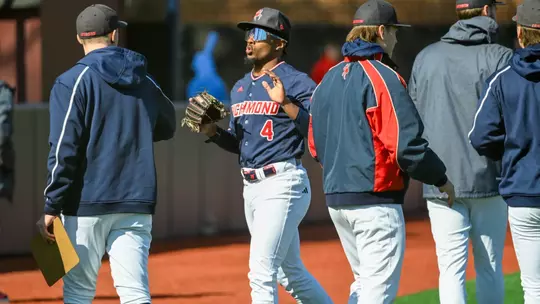 RJ Johnson Jr high fives his teammates come into the dugout