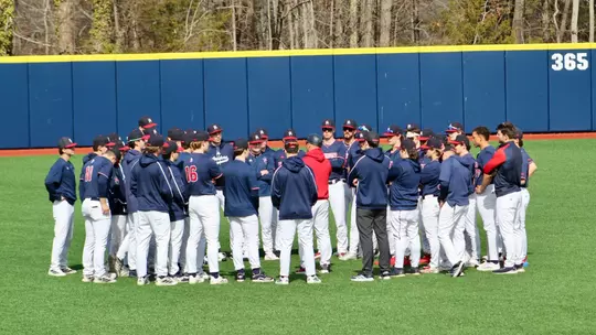 Spider Baseball huddles prior to playing Penn State