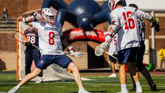 Charlie Packard and Jack Ricciardi celebrate a goal against Virginia on Feb. 14, 2026