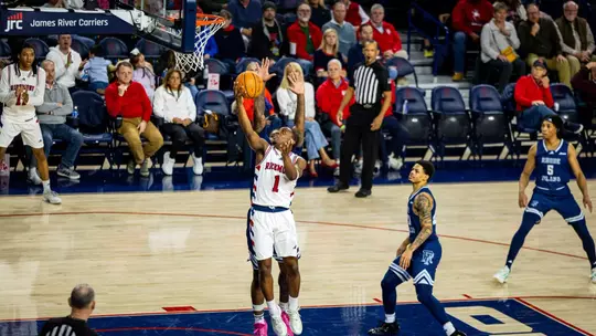 Mikkel Tynes shoots a reverse layup against Rhode Island