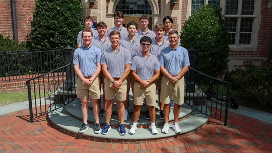 The 2025-26 men's golf team gathers on a staircase for a team photo
