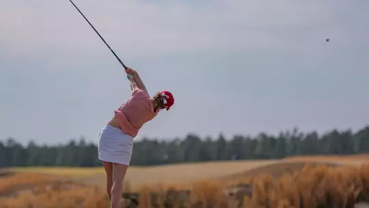 A shot from behind Hannah Lydic as she tees off with her driver