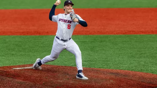 Chase Topolski strides towards home plate from the pitching rubber.