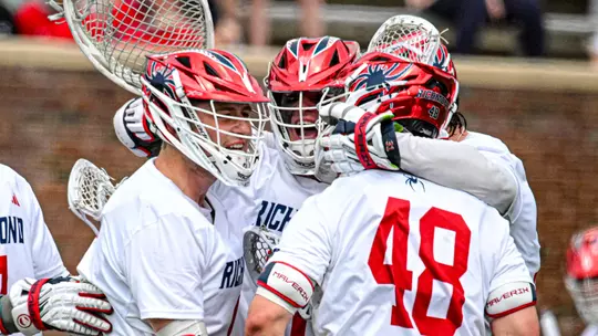 Spider men's lacrosse defenders celebrate a goal against Georgetown on March 7, 2026