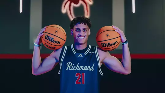 Jamie Kaiser Jr. poses with two basketballs