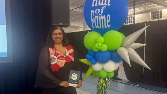LaRee Sugg poses with her Chesterfield Sports Hall of Fame plaque