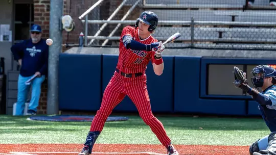 Evan Wilson lays off a high pitch against URI