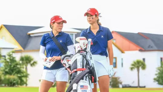 Calle Barlow and Katie Magner speak on the fairway