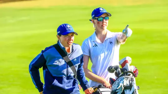 Calle Barlow and Addie Doroh stare at the green as Doroh points