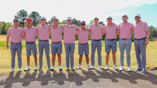 The Richmond Spiders men's golf team poses next to the 18th green at Independence Golf Club