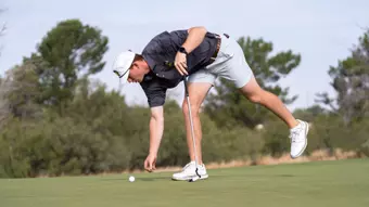 Leid marks his ball during the Final Round of the Tall City Classic