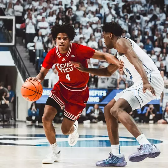 Christian Anderson drives past a BYU defender for a basket.