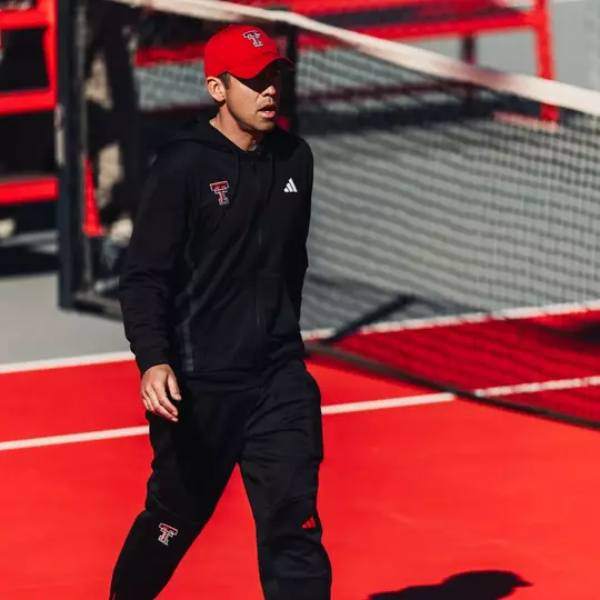 Head Men's Tennis Coach Michael Breler crosses through a court during the Red Raiders Contest vs. ORU