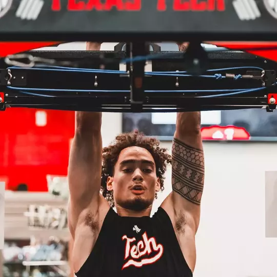 Dra Gibbs-Lawhorn does pullups in the Texas Tech basketball weight room during a summer workout.