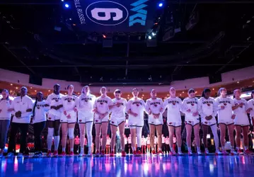 Team standing arm in arm before playing Portland in the WCC Tournament