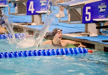 Julia Dennis celebrates her silver medal in the 50 free