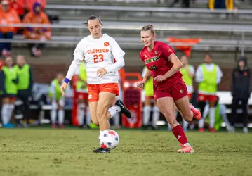 Fina Davy races a Clemson player to the ball