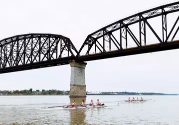 Louisville rowing under the bridge on the Ohio River