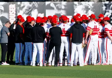 Baseball team huddled in the outfield