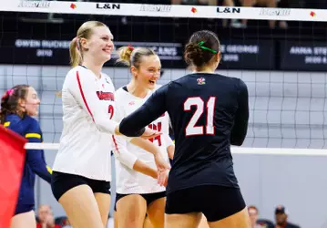 Chloe Meester, Brooke Bultema and Payton Petersen celebrate a point against California
