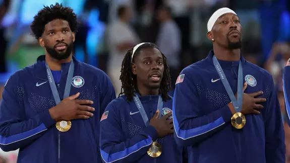 PARIS, FRANCE - AUGUST 10: Joel Embiid, Jrue Holiday, and Bam Adebayo of Team United States look on on the podium during the Men's basketball medal ceremony on day fifteen of the Olympic Games Paris 2024 at Bercy Arena on August 10, 2024 in Paris, France. (Photo by Ezra Shaw/Getty Images)