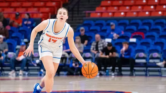 Mya Hansen dribbles the ball to her left.