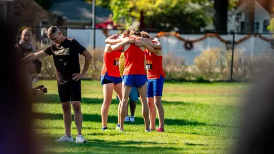 Men's cross country team huddling