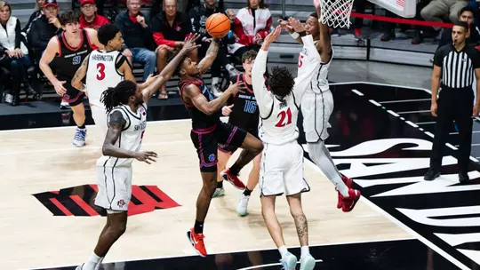 Dylan Andrews attempting a layup with SDSU defenders surrounding him