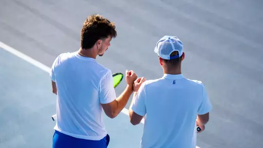 Two men's tennis players talking