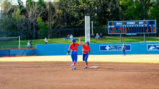 Quinn Southerland and Jorja Crider high five at second base.