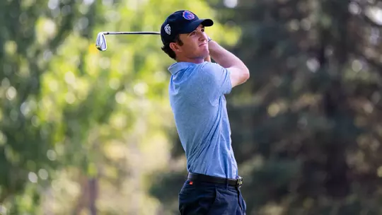 Luke Cushman watches the flight of the ball following a swing during a practice round