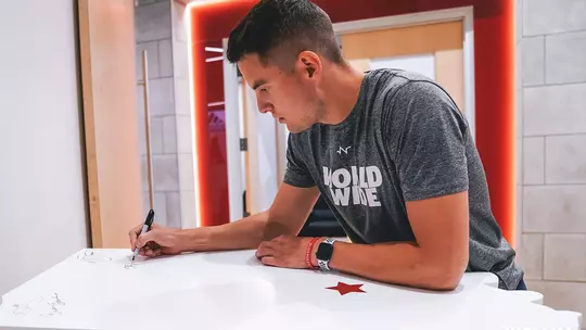 Nick Zeisloft signs Alumni Wall