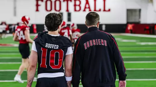 BLOOMINGTON, IN - March 28, 2026 - quarterback Josh Hoover #10 of the Indiana Hoosiers and Indiana Hoosiers Head Coach Curt Cignetti during spring practice at John Mellencamp Pavillion in Bloomington, IN Photo By Luke Miller/Indiana Athletics