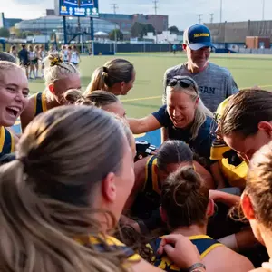Field hockey team huddle celebration